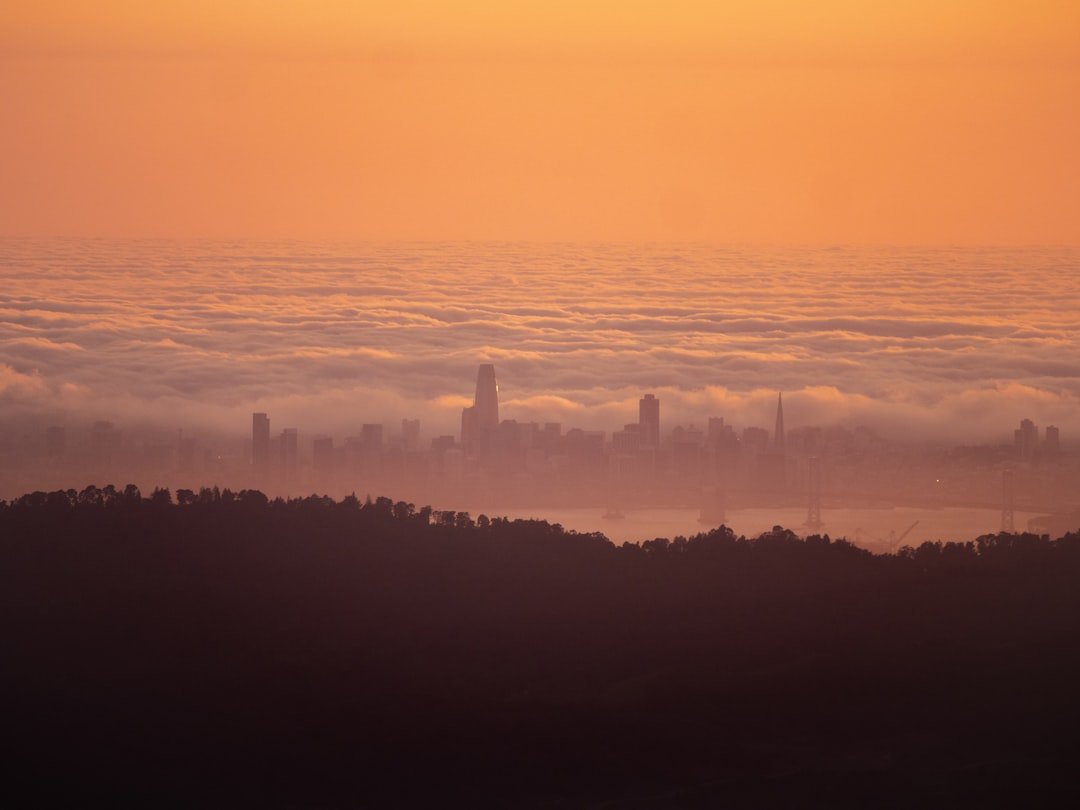 San Francisco Bay Area skyline at sunrise with morning fog, representing the innovative tech culture of Silicon Valley